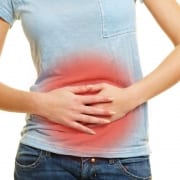 woman with crohn's disease holding her stomach