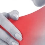 woman holding her painful shoulder due to frozen shoulder