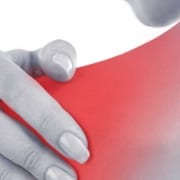 woman holding her painful shoulder due to frozen shoulder