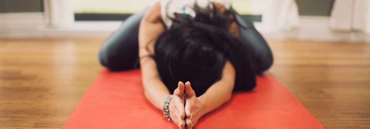 woman practicing yoga / mind body therapy