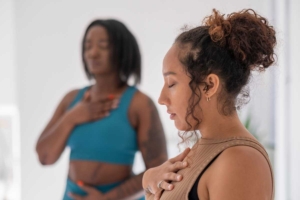 Women practicing pranayama in yoga studio
